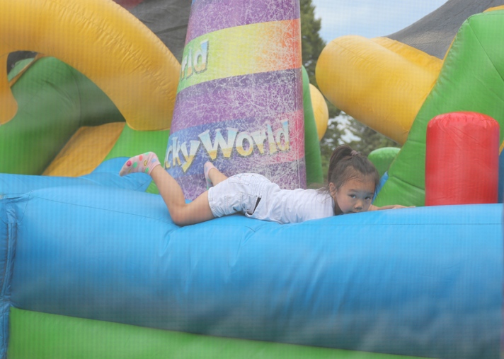 A girl bounces in a bouncy house