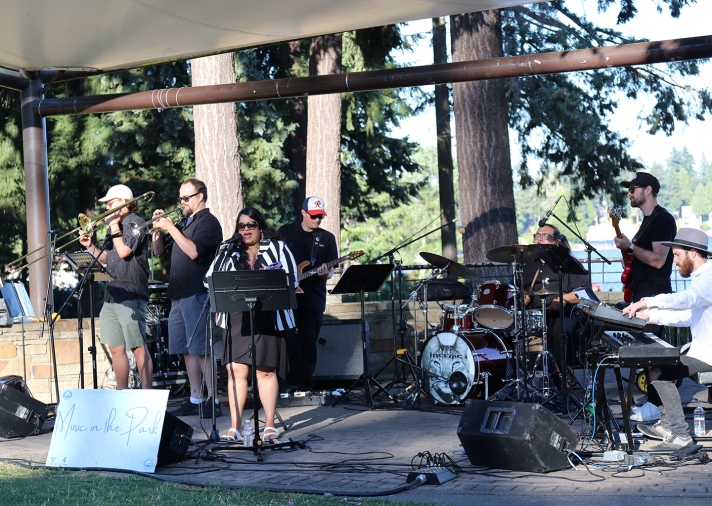 A band performs at Angle Lake Park with the lake in the background